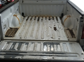 Rusty metal truck bed that needs a spray on bed liner job